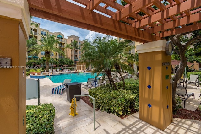 view of pool with a pergola and a patio