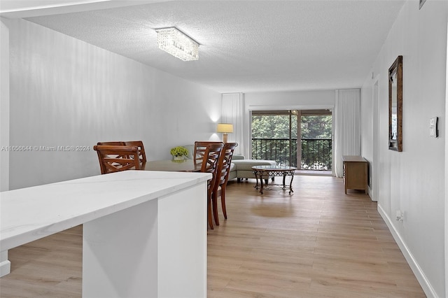 kitchen featuring a textured ceiling and light hardwood / wood-style flooring