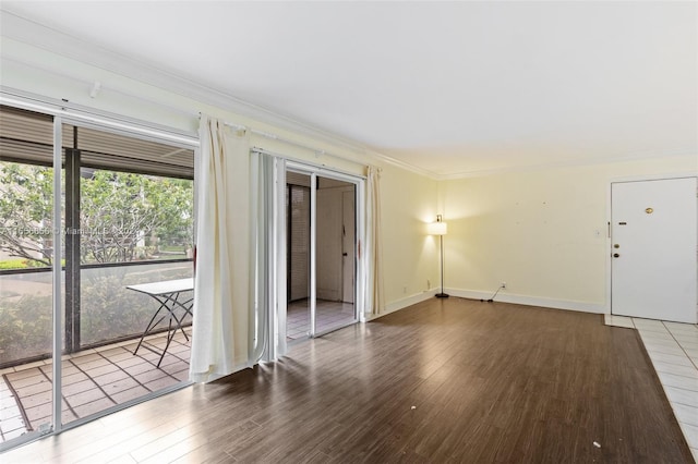 empty room with crown molding and hardwood / wood-style flooring