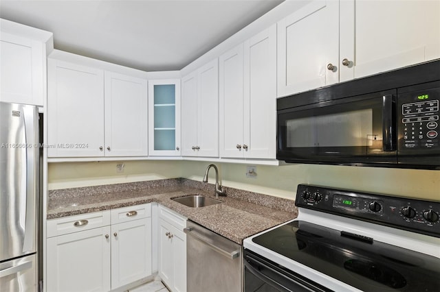 kitchen with black appliances, white cabinetry, and sink