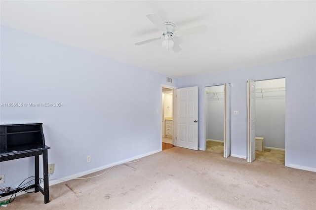 unfurnished bedroom featuring ceiling fan and light carpet