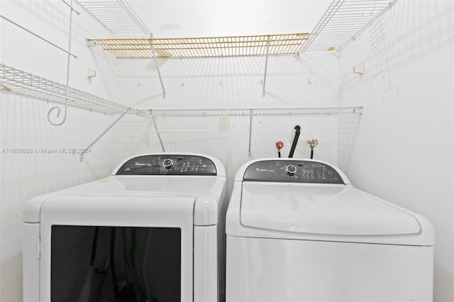 clothes washing area with separate washer and dryer