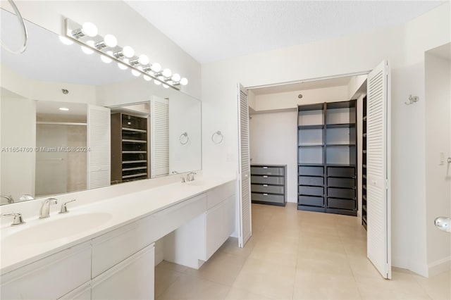 bathroom featuring vanity, a textured ceiling, an enclosed shower, and tile patterned floors