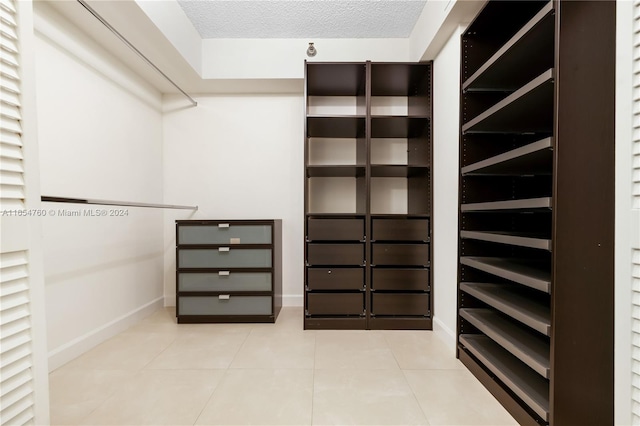 walk in closet with tile patterned flooring