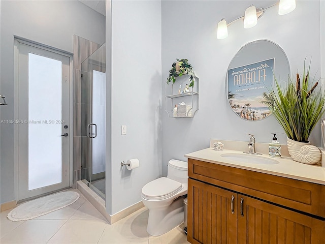 bathroom featuring toilet, a shower with shower door, vanity, and tile patterned flooring