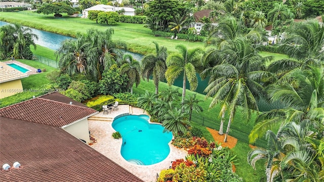 view of swimming pool featuring a patio and a yard