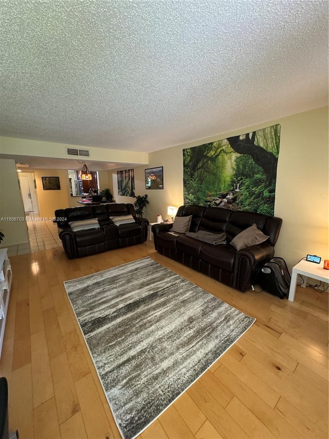 living room featuring hardwood / wood-style flooring and a textured ceiling