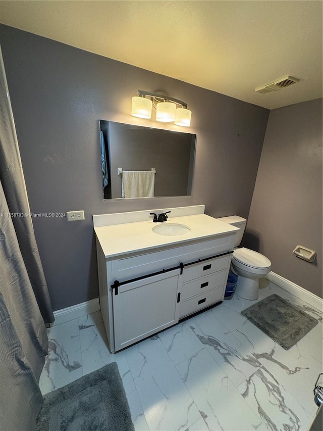 bathroom featuring vanity and toilet