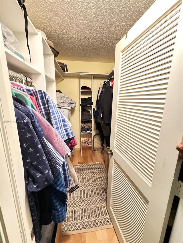 walk in closet featuring light hardwood / wood-style flooring