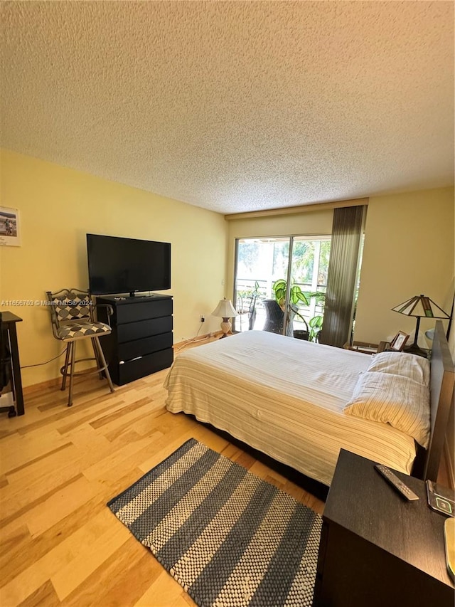 bedroom featuring a textured ceiling and hardwood / wood-style floors