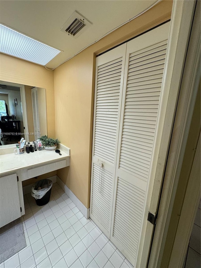 bathroom with tile patterned flooring and vanity