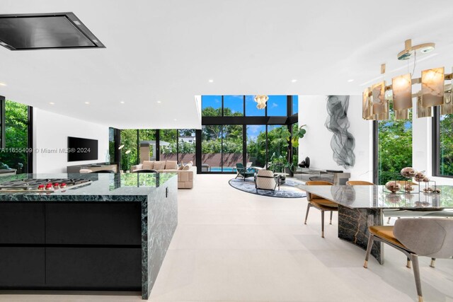 living room with an inviting chandelier and expansive windows