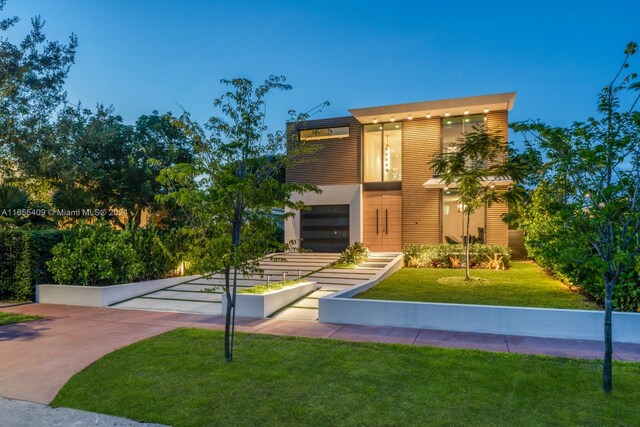 contemporary house with a garage and a front yard