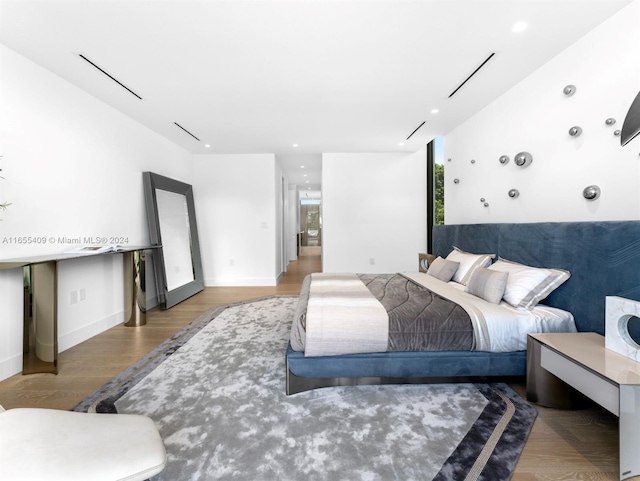 bedroom with wood-type flooring