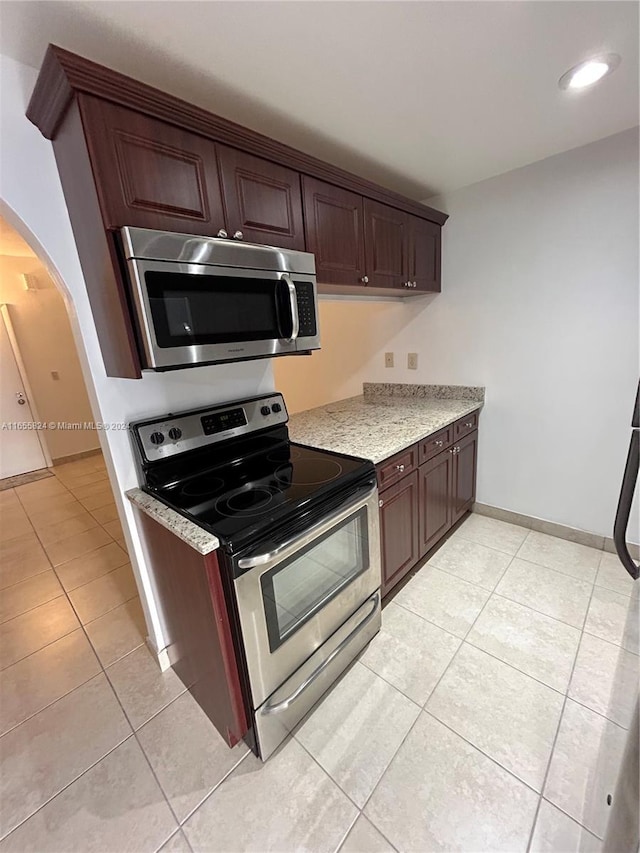 kitchen featuring appliances with stainless steel finishes and light tile patterned flooring