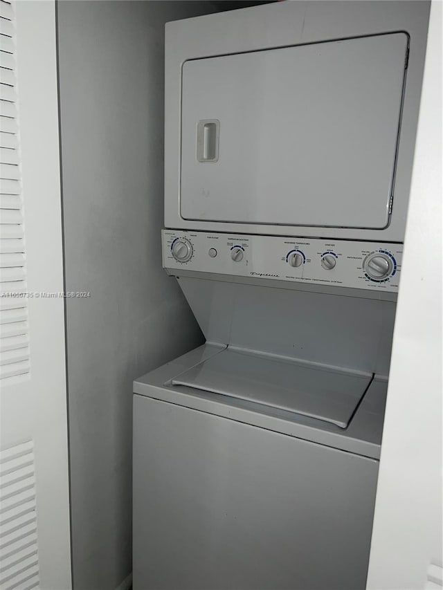 washroom featuring stacked washer and dryer