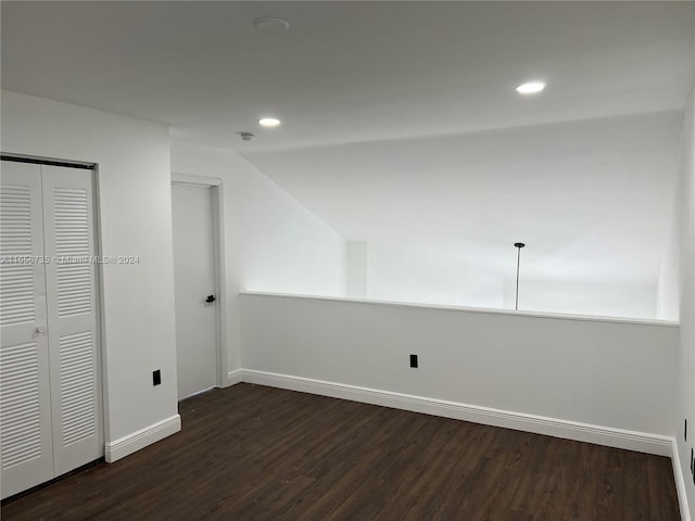 additional living space featuring dark wood-type flooring