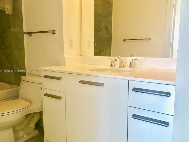 bathroom featuring vanity, toilet, and tiled shower