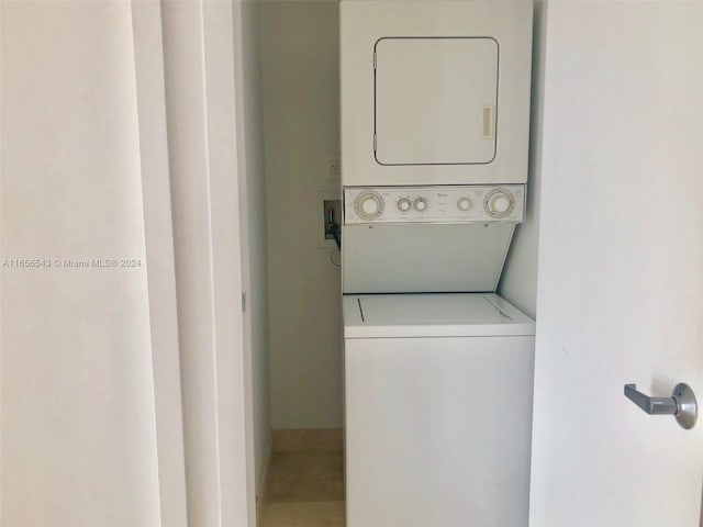 washroom featuring stacked washing maching and dryer