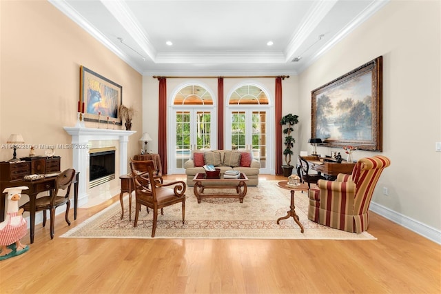 dining space featuring ornamental molding, light wood-type flooring, and ornate columns