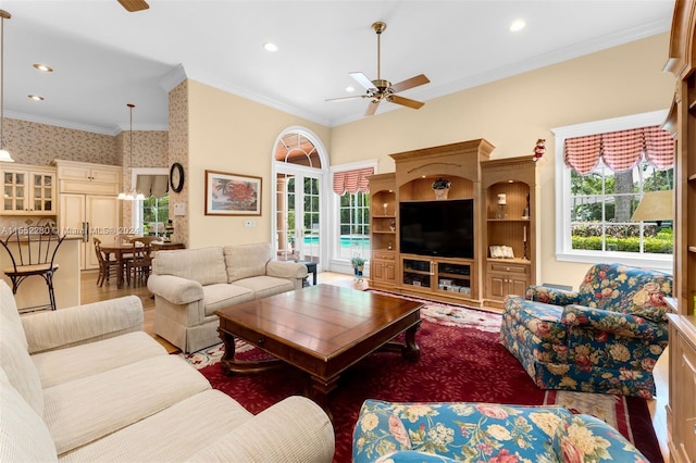 living room with crown molding, ceiling fan, and hardwood / wood-style flooring