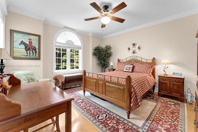 bedroom with light wood-type flooring, ceiling fan, and crown molding