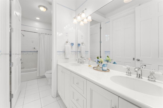 full bathroom with shower / bath combo with shower curtain, tile patterned floors, vanity, and toilet