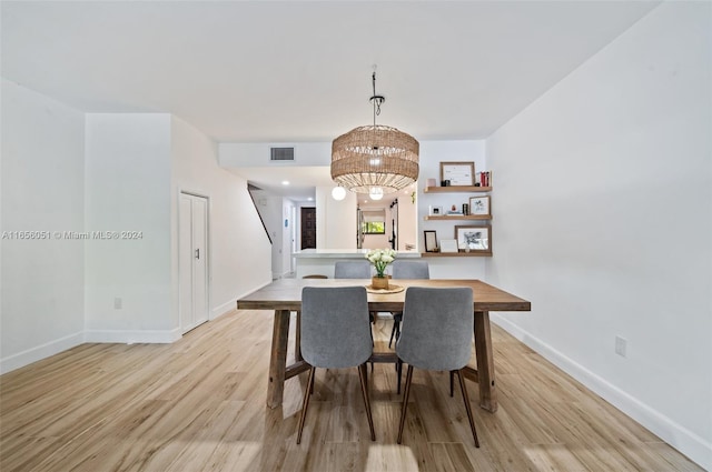 2600 Cardena St Unit 11, Coral Gables, FL 33134 - dining room with light wood-style flooring, baseboards, and a chandelier