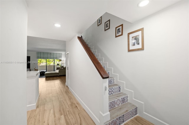 stairway featuring wood-type flooring