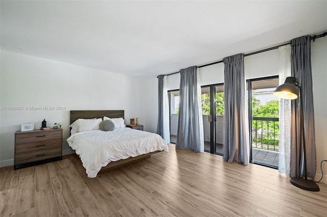 bedroom with access to outside and light hardwood / wood-style flooring