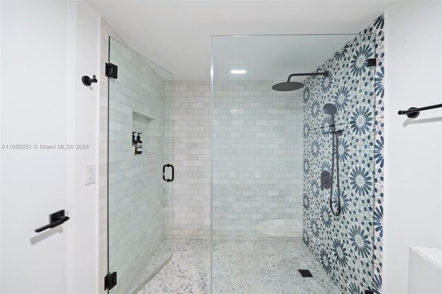 bathroom with a shower with shower door