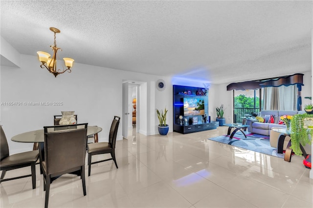 900 NE 195th St Unit 317, Miami, FL 33179 - dining area featuring a textured ceiling, a chandelier, tile patterned floors, and baseboards