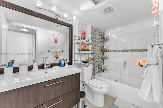 900 NE 195th St Unit 317, Miami, FL 33179 - full bathroom featuring vanity, shower / bath combination with glass door, and toilet