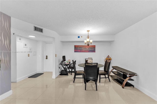 900 NE 195th St Unit 317, Miami, FL 33179 - dining area with a chandelier, light tile patterned flooring, baseboards, and a textured ceiling