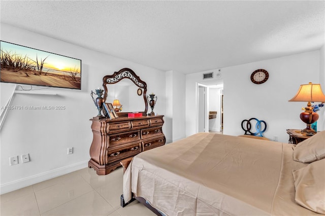 900 NE 195th St Unit 317, Miami, FL 33179 - bedroom featuring tile patterned floors, baseboards, and a textured ceiling