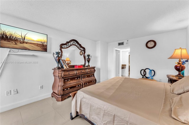 bedroom featuring a textured ceiling and light tile patterned flooring