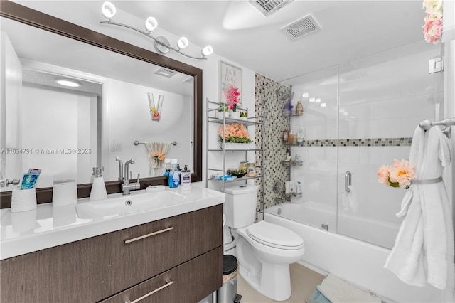 full bathroom with vanity, enclosed tub / shower combo, and toilet