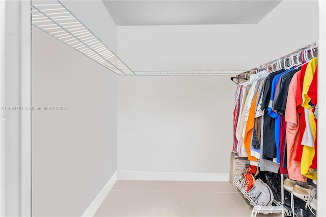 spacious closet featuring light tile patterned floors