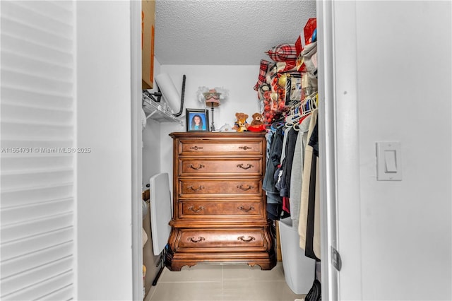 spacious closet with light tile patterned floors