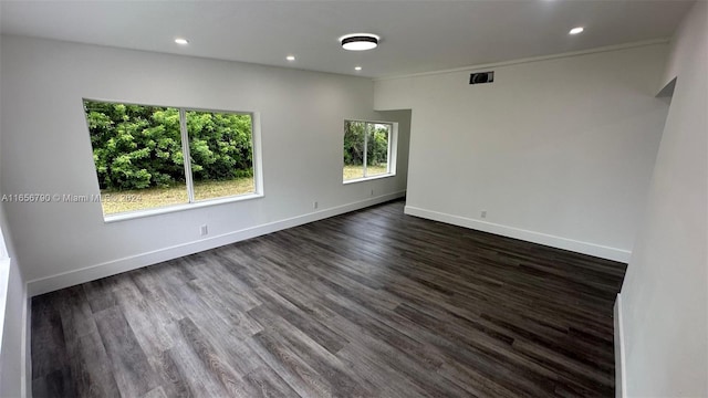 empty room featuring dark hardwood / wood-style flooring