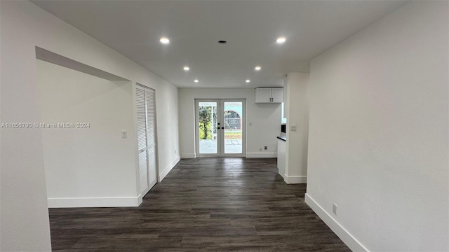 corridor featuring dark wood-type flooring and french doors