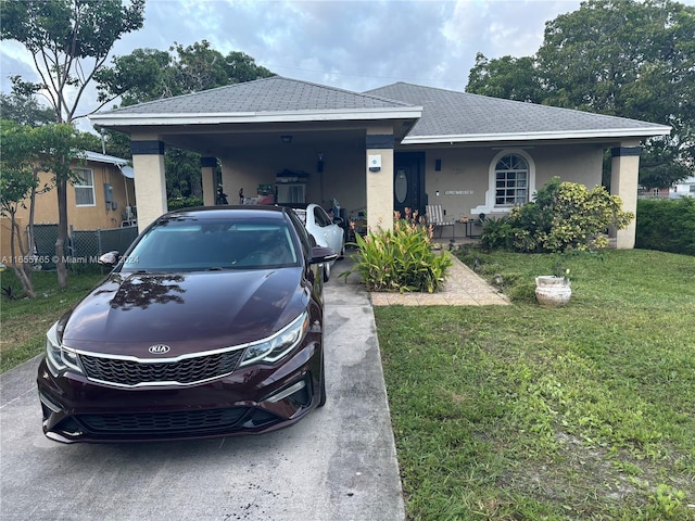 2239 Atlanta St, Hollywood, FL 33020 - view of front of home featuring covered porch, a carport, stucco siding, and a front yard
