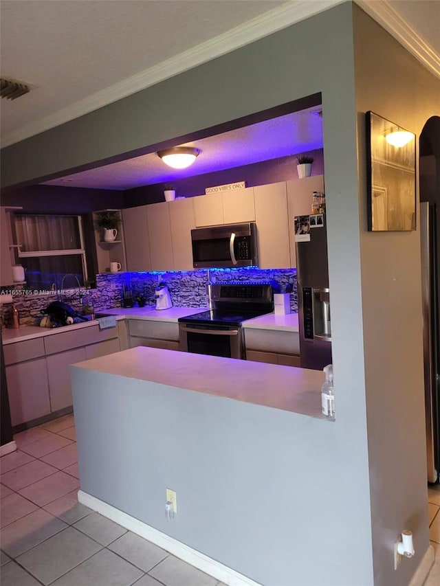 kitchen with crown molding, light tile patterned floors, stainless steel appliances, and decorative backsplash