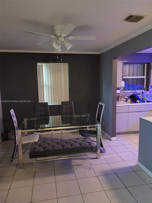 tiled dining room featuring ceiling fan and ornamental molding