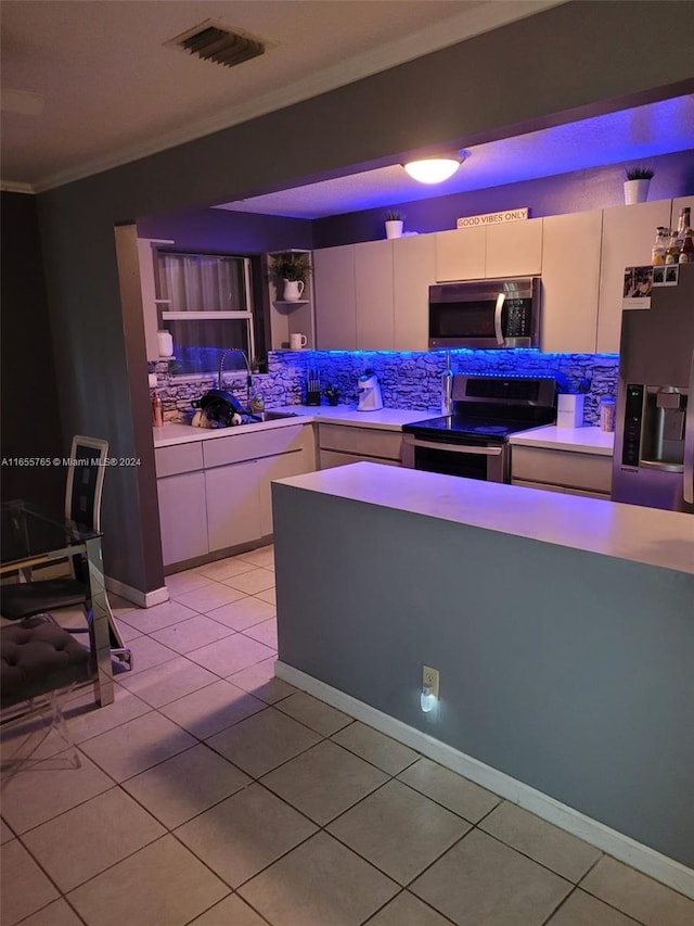 kitchen featuring ornamental molding, appliances with stainless steel finishes, sink, and light tile patterned flooring