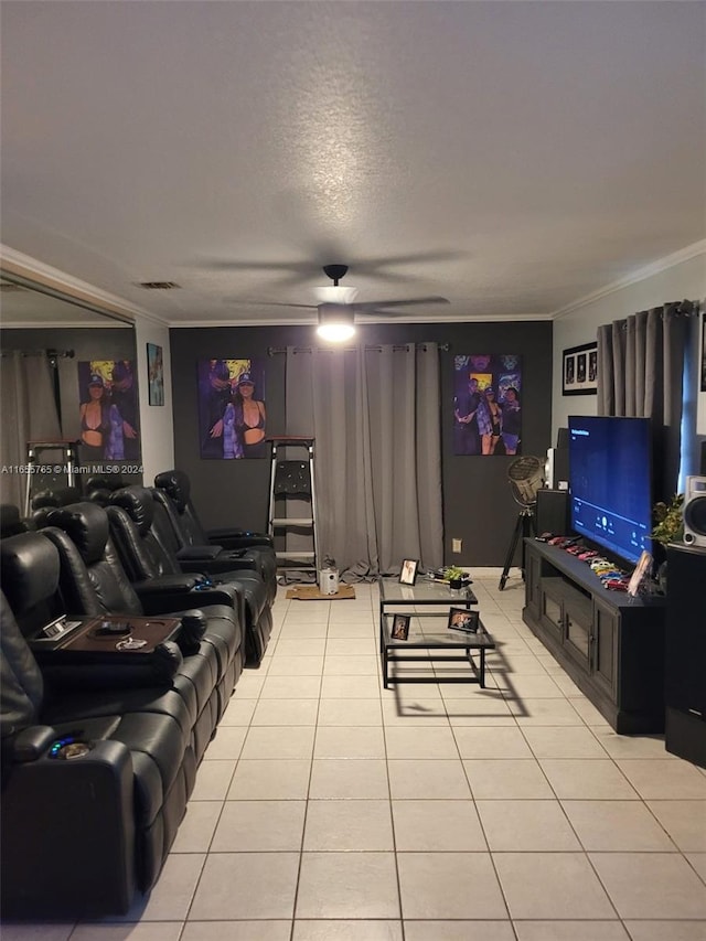 living room featuring ceiling fan, light tile patterned floors, ornamental molding, and a textured ceiling