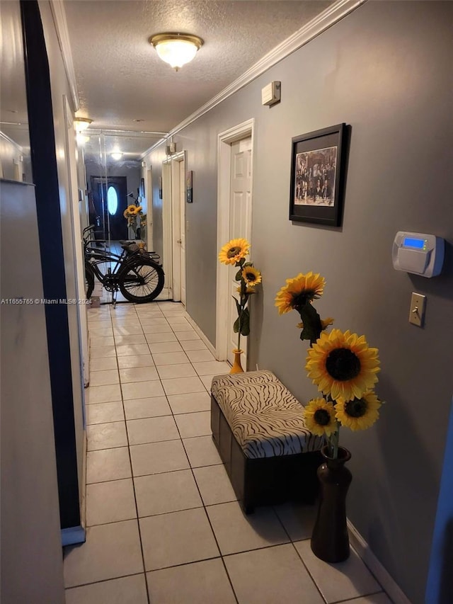 2239 Atlanta St, Hollywood, FL 33020 - corridor with a textured ceiling, baseboards, light tile patterned flooring, and ornamental molding