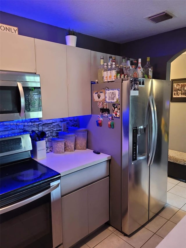 kitchen featuring appliances with stainless steel finishes and light tile patterned floors