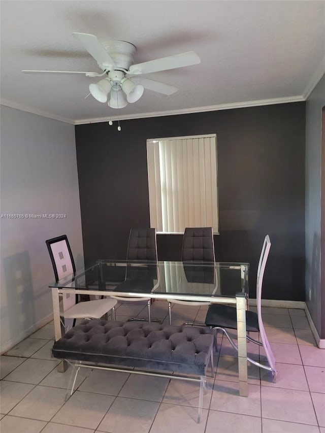 tiled dining room featuring ceiling fan and ornamental molding