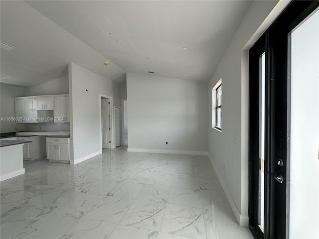 unfurnished living room with lofted ceiling